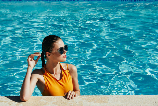 Young beautiful woman relaxing in the pool   - Zdjęcie, obraz