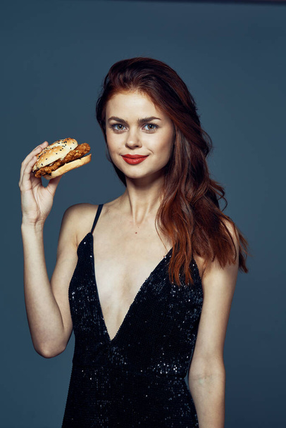 Young beautiful woman with hambyrger. Studio shot - Zdjęcie, obraz