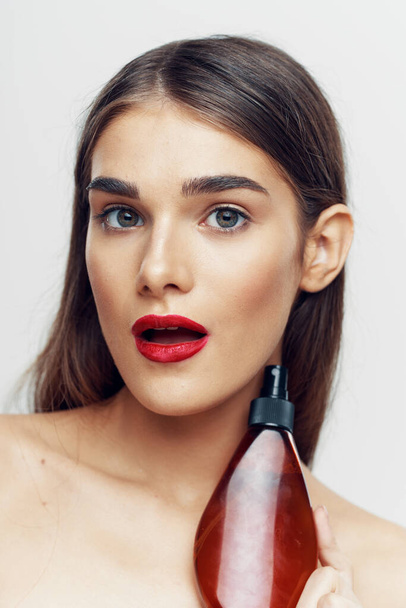 Young beautiful woman with beauty product  in studio  - Fotoğraf, Görsel