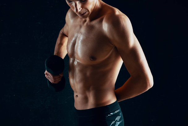 Young man with dumbbell in studio  - Photo, Image