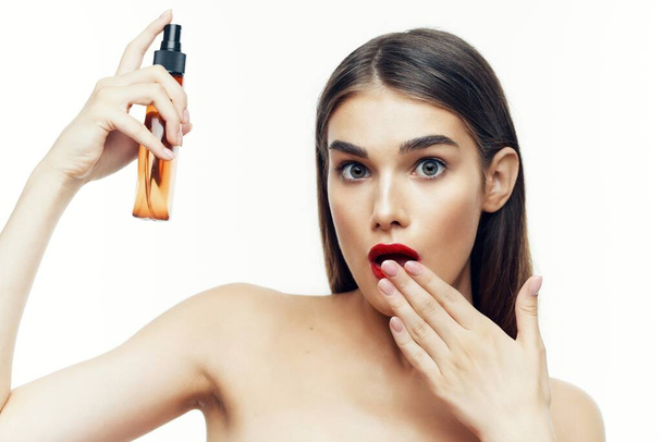 Young beautiful woman with beauty product  in studio  - Foto, immagini