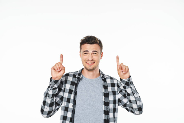 Young  man  pointing up  in studio,  isolated on white background - Photo, Image