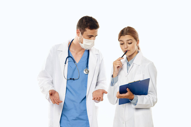 Young doctors talking  in studio, isolated background.  - Photo, Image