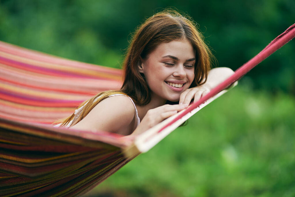 Young beautiful woman relaxing in hammock  - Photo, image