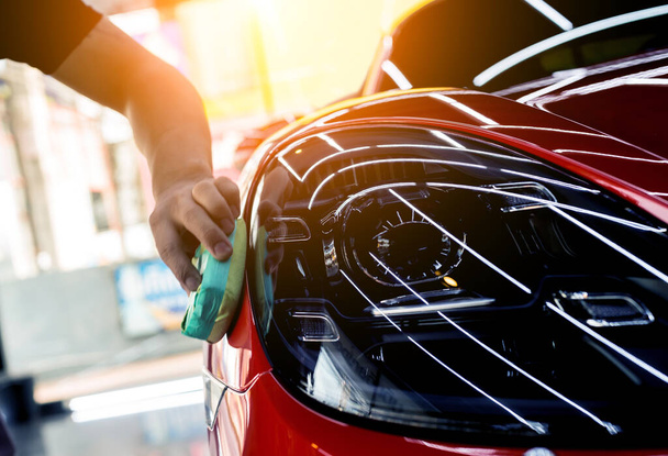 Car service worker applying nano coating on a car detail - Foto, immagini