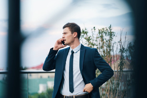 Young handsome businessman  taking on smartphone   - Φωτογραφία, εικόνα