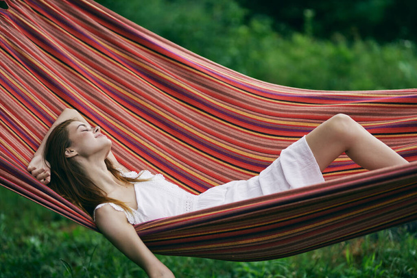 Young beautiful woman relaxing in hammock  - Photo, Image