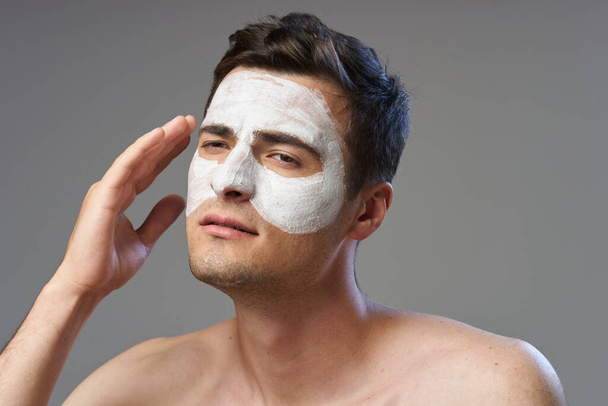Young handsome man with face mask   looking away  in studio  - Photo, image