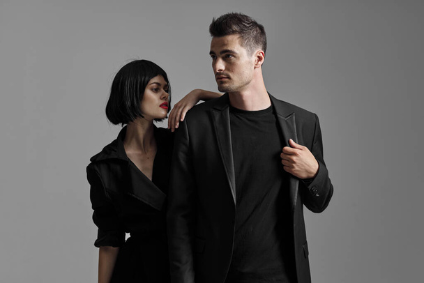 Young beautiful couple in black posing in studio - Foto, Imagen