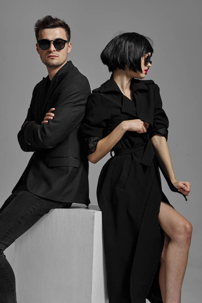 Young beautiful couple in black posing in studio - Valokuva, kuva