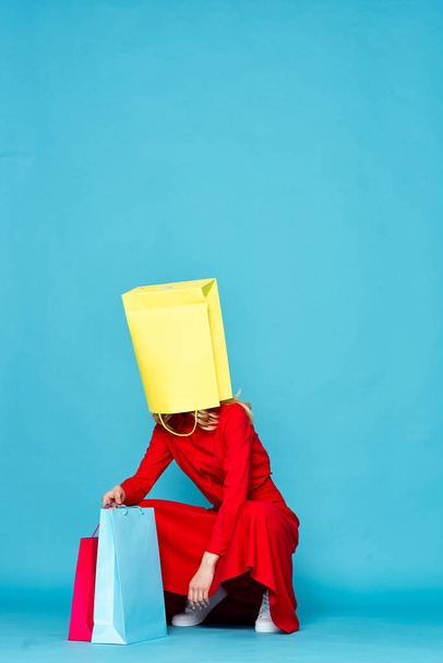 young beautiful woman with shopping bag on her head                 - Фото, зображення