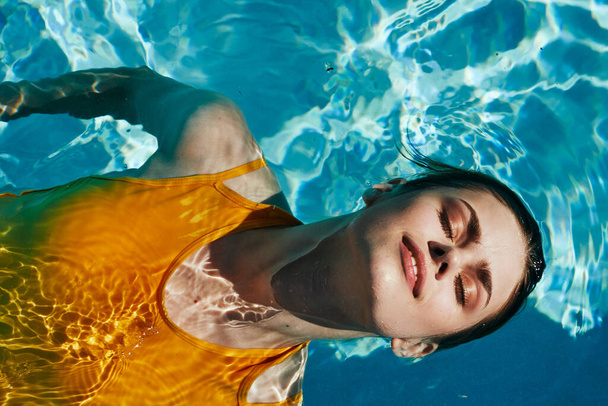 Young beautiful woman relaxing in the pool   - Fotó, kép