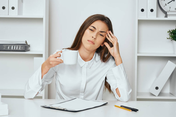 Young beautiful businesswoman sitting at desk in the office with headache  - Foto, Bild