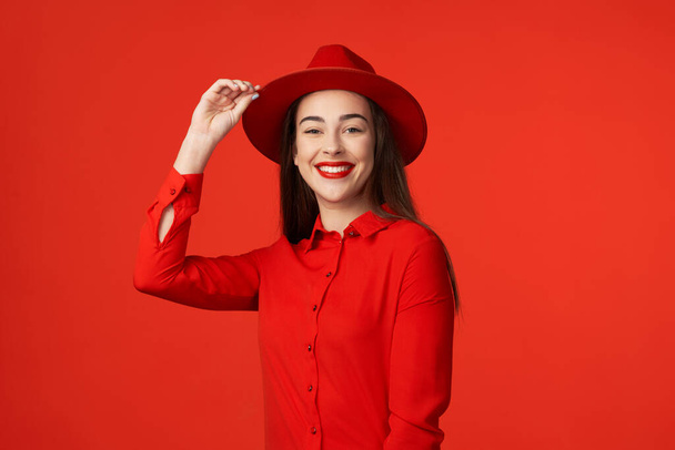 Studio shot. Young beautiful woman wearing  red  isolated on red background - Valokuva, kuva