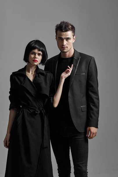Young beautiful couple in black posing in studio - Foto, imagen