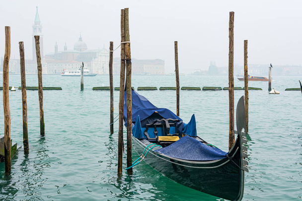 Gondolas in Venice, Italy. Beautiful view of Venice from San Marco embankment. - Фото, изображение