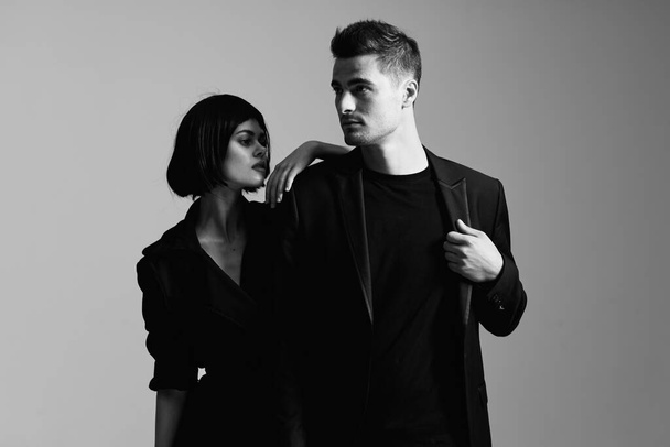 Young beautiful couple posing in studio. Black and white - Zdjęcie, obraz