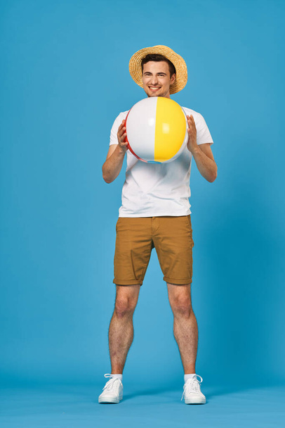 Young man playing with ball in studio  - Фото, зображення