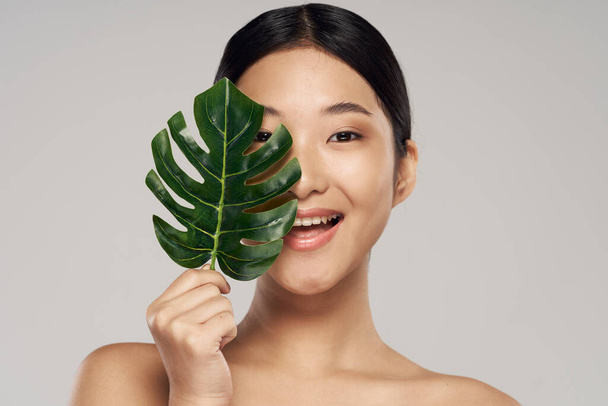 portrait of young asian woman with leaf  - Φωτογραφία, εικόνα