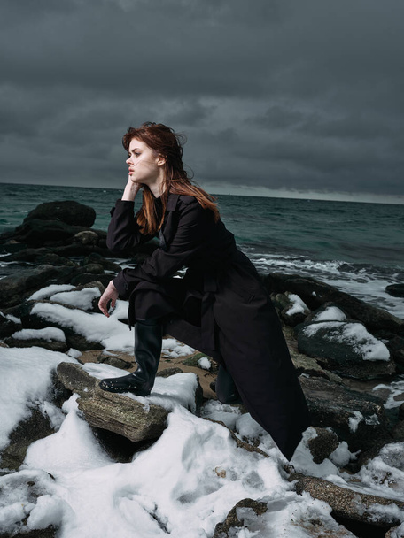  Beautiful young woman posing on winter beach - Photo, image