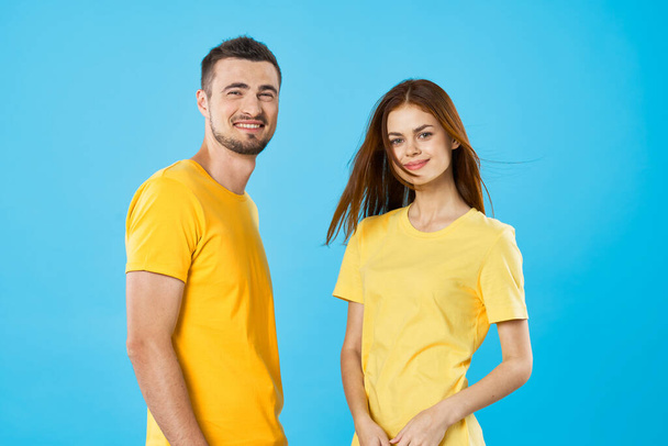 young beautiful couple in  t-shirts posing in studio on isolated background - Foto, Bild