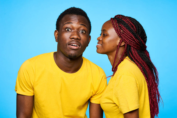 young beautiful couple posing in studio on blue background - Foto, immagini