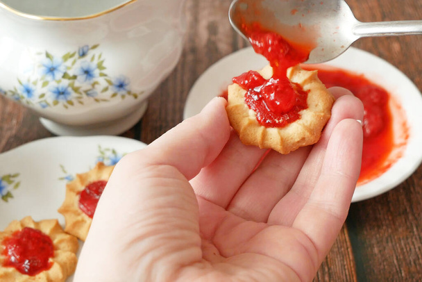 tea drinking with biscuits and delicious tasty strawberry jam, still life, closeup - Photo, Image