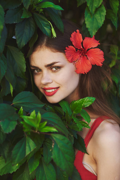 Young beautiful woman posing with flower in her hair - Photo, Image