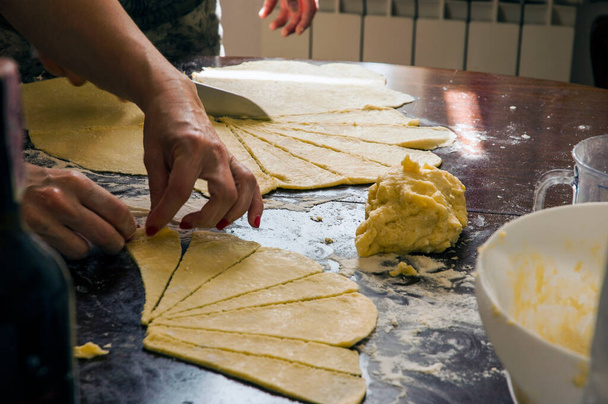 A process of puff pastry cutting into thin slices surrounded with flour - Photo, Image