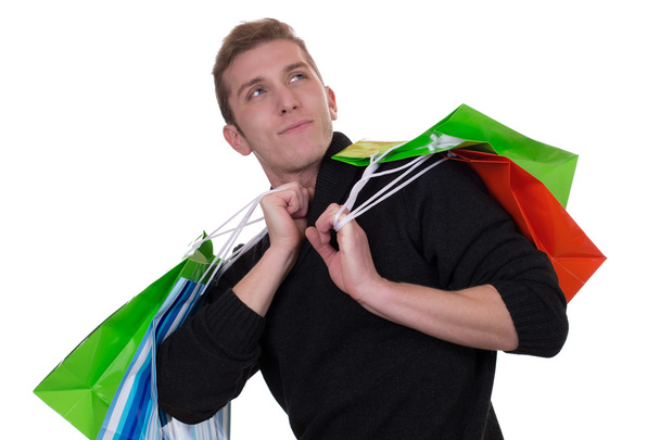 Young man with shopping bags looking up - Foto, Imagem