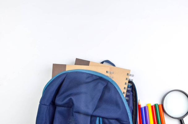 View of flat lay with school backpack and stationery with space for text on white background. Selective focus. - Fotografie, Obrázek