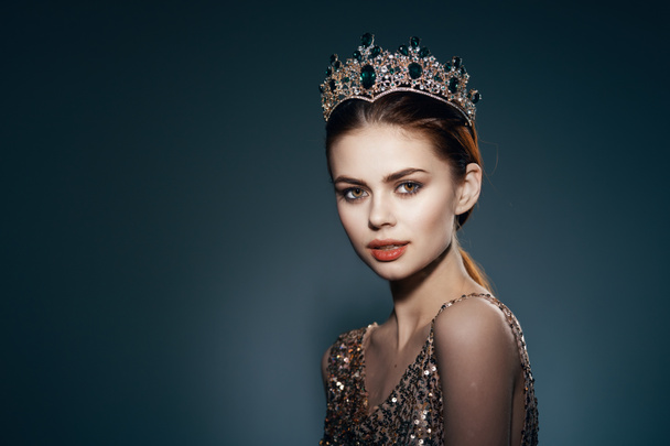 Beautiful woman with crown posing in studio. High quality photo - Photo, Image