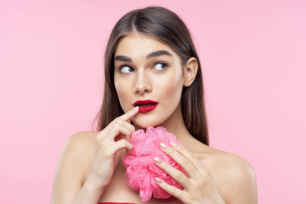 Skincare and beauty. Portrait of young beautiful woman with washcloth on pink background - Fotoğraf, Görsel