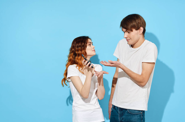 young couple with smartphone in studio  - Photo, Image