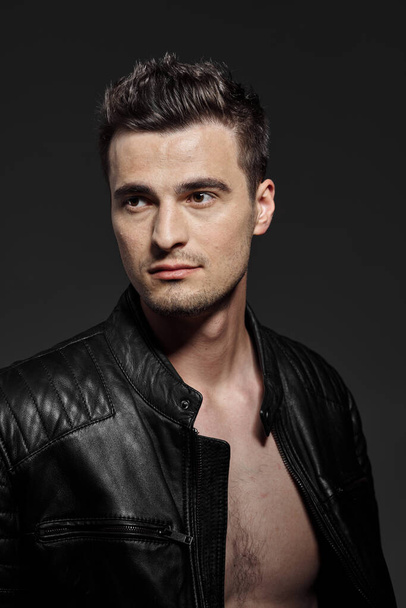 portrait of young handsome man in leather jacket. Studio shot. Fashion photography - Фото, зображення