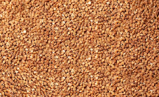 Background of raw buckwheat cereals from above - Fotografie, Obrázek