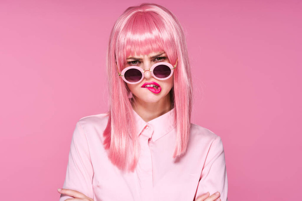 young beautiful woman in pink wig and sunglasses posing in studio  - Photo, Image