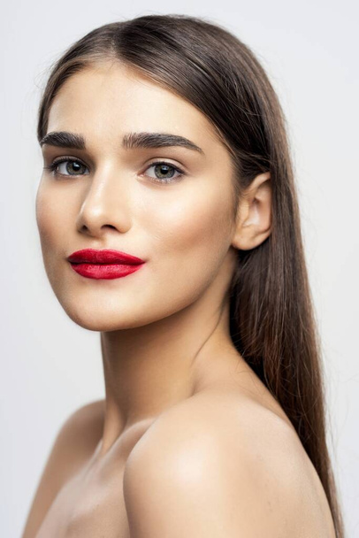 Portrait of young beautiful woman with  red lipstick on her lips. Beauty, fashion photography  - 写真・画像