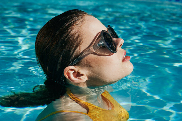 junge schöne Frau entspannt sich im Pool   - Foto, Bild
