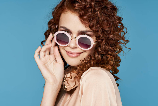young beautiful woman in sunglasses posing in studio - Photo, Image
