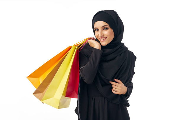 young arabian woman with shopping bags  in studio                         - Fotó, kép
