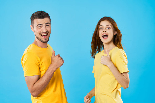 Young beautiful couple  in studio with thumbs up  - Photo, Image