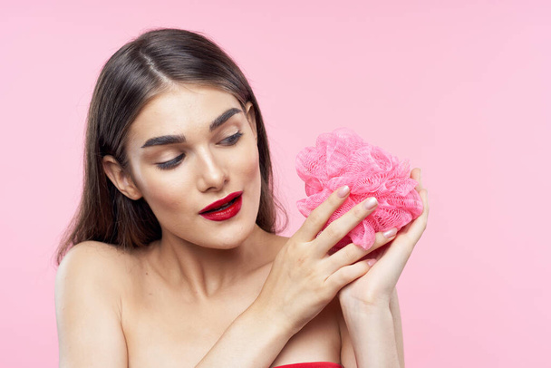 Skincare and beauty. Portrait of young beautiful woman with washcloth on pink background - Photo, Image
