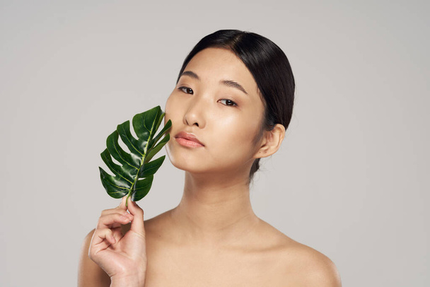 portrait of young asian woman with leaf    - Фото, изображение