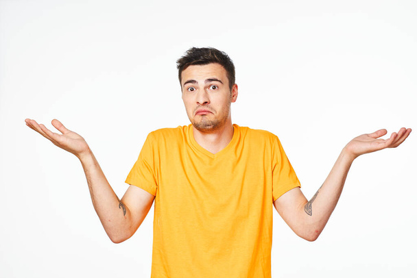 Young handsome man confused   in studio,  isolated background - Photo, Image