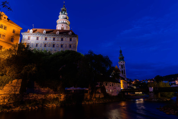 Panoramic landscape view of the historic city of Cesky Krumlov during sunset with famous Cesky Krumlov Castle, Church city is on a UNESCO World Heritage Site captured during spring with nice sky and clouds - Photo, Image