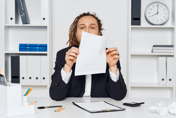 Young businessman sitting in the office with paper - Photo, Image