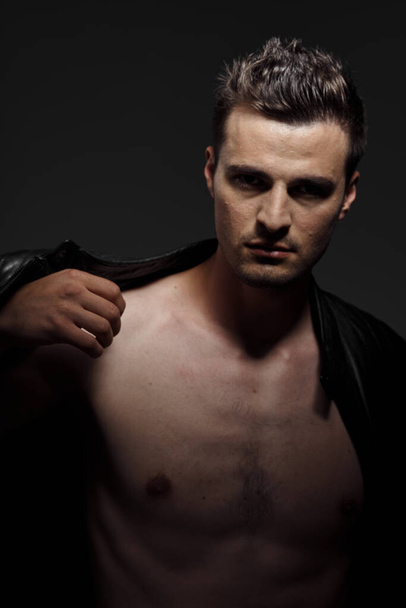 Portrait of young handsome  naked man  on dark background   - Foto, Imagen