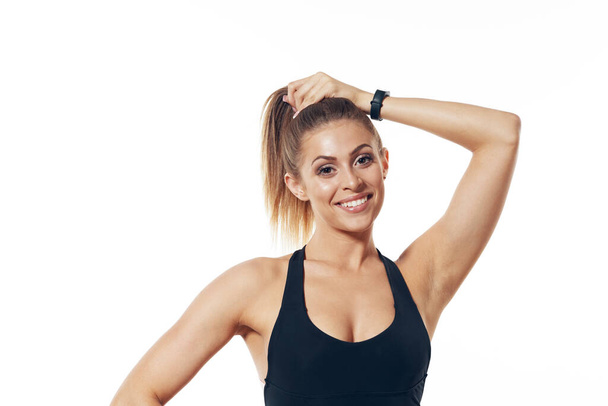 Studio shot. Young fit woman stretching, isolated background - Foto, immagini