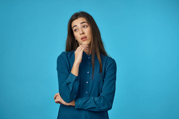 Young woman  is sad  in studio isolated on blue background  - Foto, afbeelding